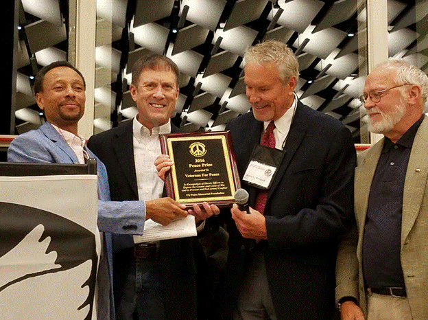 A group of men holding a plaque

AI-generated content may be incorrect.